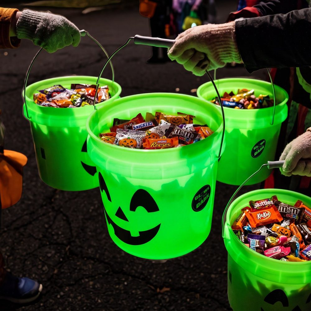 Green jack-o’-lantern buckets filled with candy