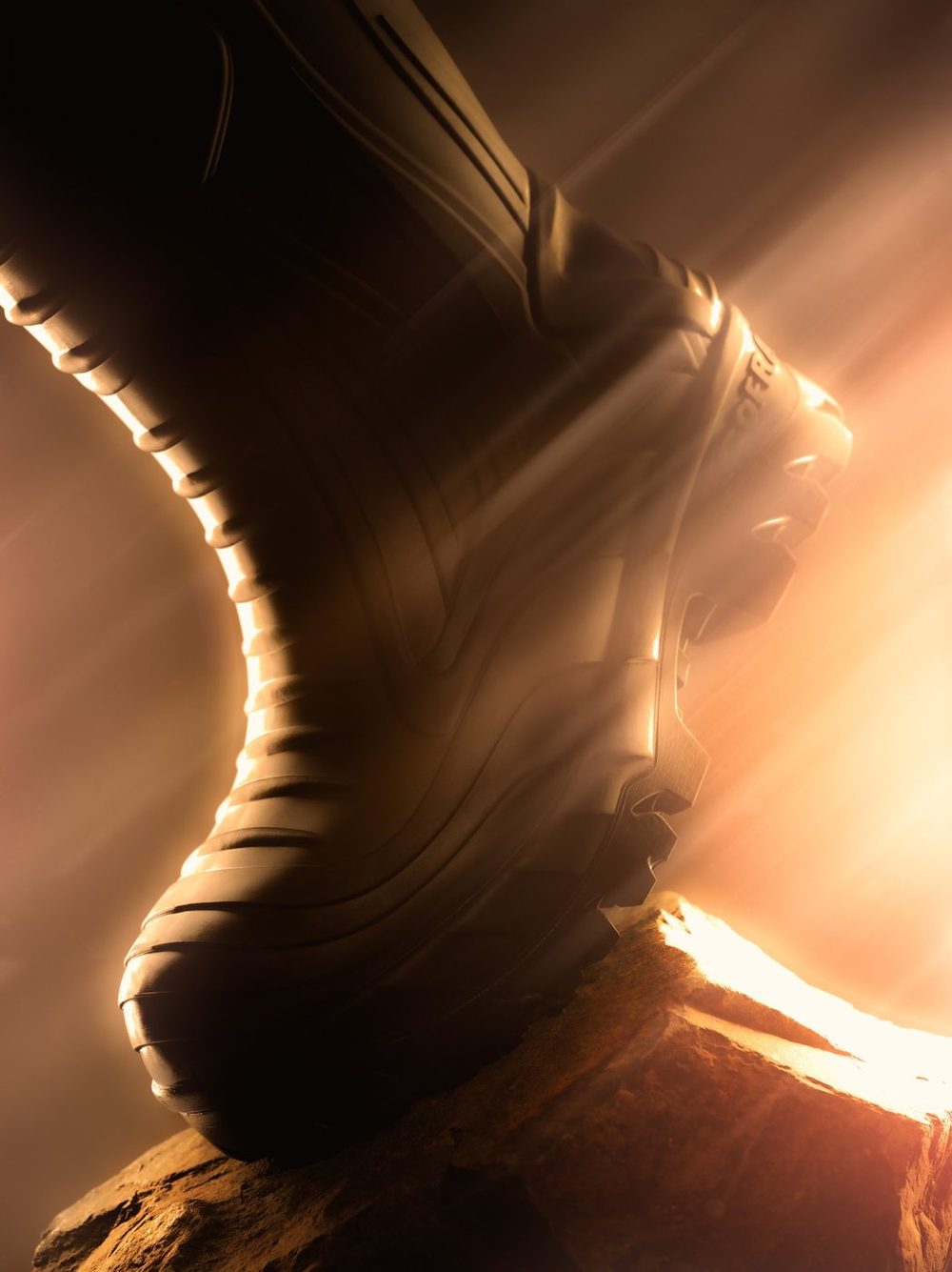 Cofra work boot rim-lit in warm light