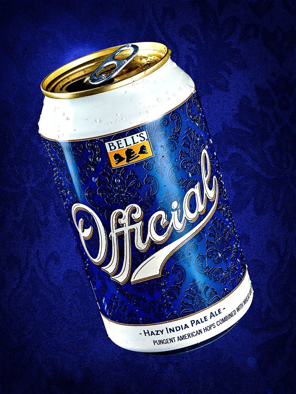 Bell’s Official craft beer can with water droplets on blue