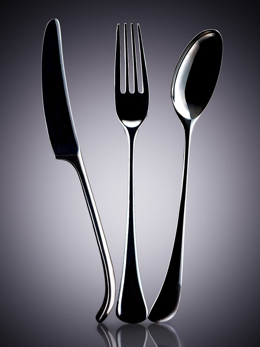 Dansk flatware: knife, fork and spoon silhouetted on grey