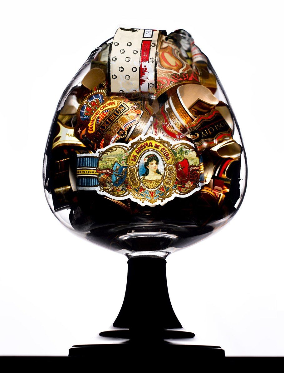 Cigar bands collected in a brandy snifter